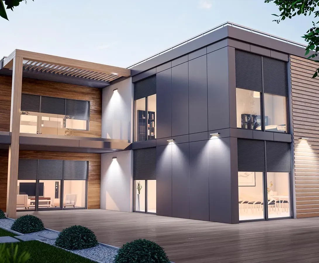 Maison contemporaine équipée de volets roulants en aluminium anthracite, éclairée à la tombée du jour